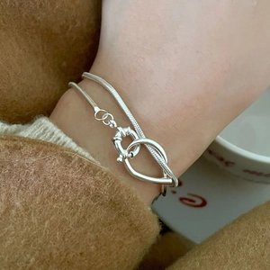 Close-up of S925 sterling silver layered bracelet with unique leaf buckle on wrist