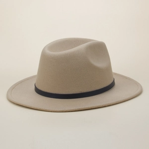 Detail view of the elegant beige wool fedora hat featuring a smooth black leather strap band