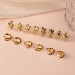 Set of 12 gold-plated earrings with zircon crowns, hearts, and pearls on pink background