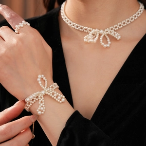 Nahaufnahme des Perlen-Schmucksets mit Schleifendesign aus Kette, Armband und Ring
