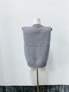 Rear view detail of a grey V-neck knitted sweater vest on a mannequin