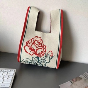 Beige knit tote bag with red rose pattern and stripe trim for daily use