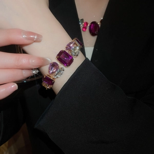 Detail shot of vintage style bracelet with purple oval and teardrop crystals on model