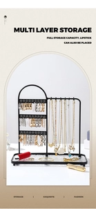 Macro view of black iron jewelry organizer with multi-layer storage for earrings and necklaces