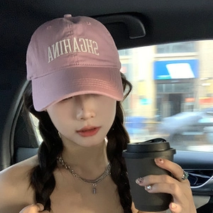 Pink baseball cap featuring white SHGAHINA embroidery on a lifestyle model