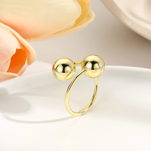 Minimalist double layer open ring in 18k gold plating featuring wire-wrapped hollow spheres