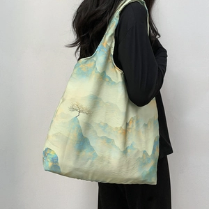 Macro detail of large canvas tote bag featuring traditional Chinese ink landscape art