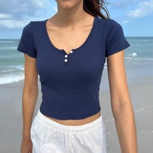 Slim fit navy blue ribbed knit crop top featuring U-neck and three buttons on beach