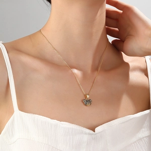 Chic gold necklace with a black crystal-encrusted bear pendant shown on a model