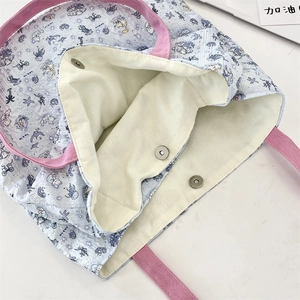 Detail of internal double magnetic buckle closure on a blue cat print canvas tote bag