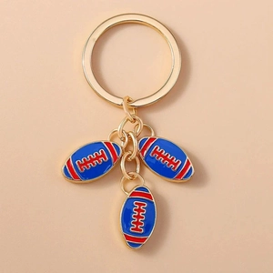 Golden keychain with three blue and red enamel American football pendants on a metal ring