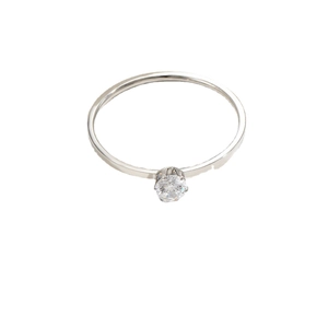 Minimalist silver titanium steel ring with a single round zircon on a white background