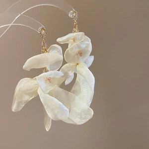 Detail of white chiffon flower tassel earrings with crystals and gold chains