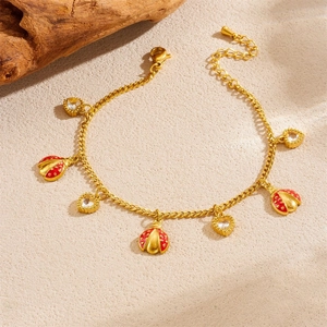 Golden ladybug and heart charm bracelet with red enamel and white zircon accents