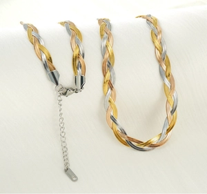 Macro shot of a tricolor braided titanium steel necklace and bracelet set with lobster clasps