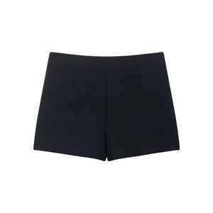 Detail shot of black high-waisted asymmetric skort featuring premium suiting fabric
