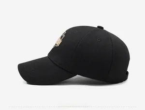 Side view of black baseball cap showing golden embroidery and six-panel structure