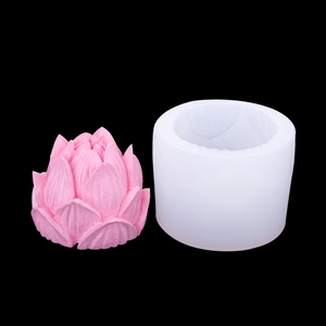 White silicone lotus flower mold with pink petal candle craft shown on black background
