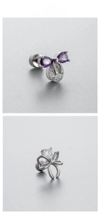 Macro shot of zircon bow earrings with titanium steel screw backs and silver details