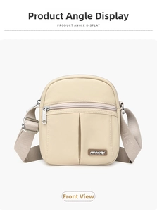 Front view of beige nylon crossbody bag with dual zipper pockets and wide strap