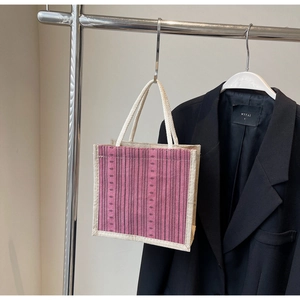 Detail of pink and purple striped linen tote bag with natural hemp rope handles