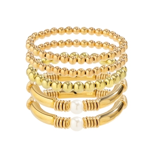 Five-piece gold metal bracelet set featuring stretch beads and faux pearl accents