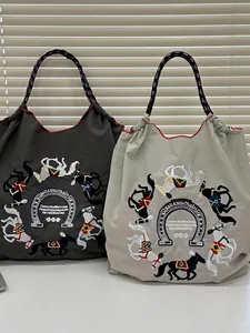 Embroidered nylon tote bag featuring horse and horseshoe motifs with braided handles