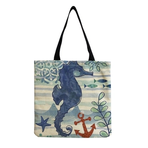 Minimalist canvas tote bag with ocean creature prints, shown in a flat lay view