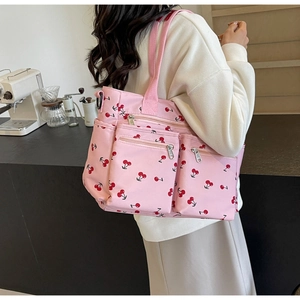 Pink tote bag with cherry print showing large capacity and multi-pockets for daily use
