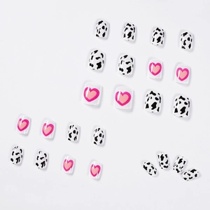 Pink heart and cow print press-on nails set with glossy finish on white background