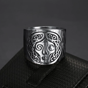 Vintage stainless steel Viking ring featuring intricate Celtic knot patterns on a black surface