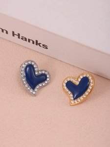 Detail of blue heart earrings with gold and silver bases and rhinestone embellishment