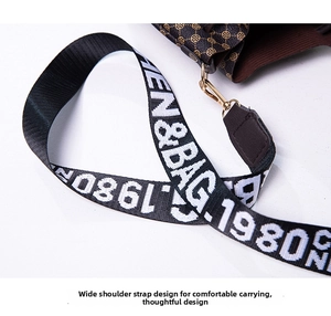 Detail of wide nylon shoulder strap with CHEN&BAG text and golden metal hooks on bucket bag