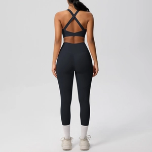 Detail of the cross-back sports bra and high-waist leggings on a yoga set