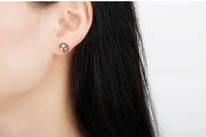 Close-up of a natural violet blue freshwater pearl stud earring on a female model