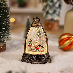 Close-up of bronze vintage Christmas lantern with Santa Claus and sparkling snow scenery