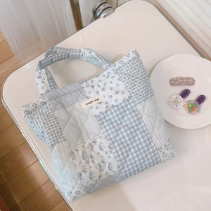 Detail of floral and checkered quilted patchwork tote bag with a simple wish label