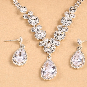 Elegant silver-toned bridal jewelry set with sparkling teardrop crystal necklace and earrings