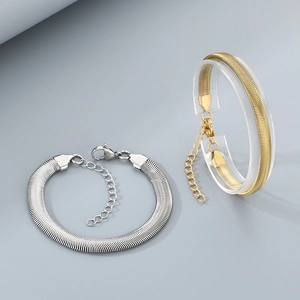 Detail of gold and silver flat snake chain bracelets with lobster clasp and extension