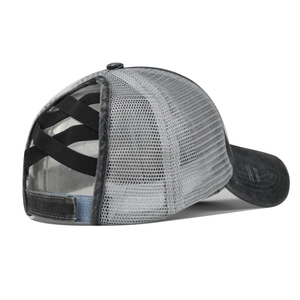 Detail of messy bun ponytail hole with black elastic criss-cross bands on a grey cap