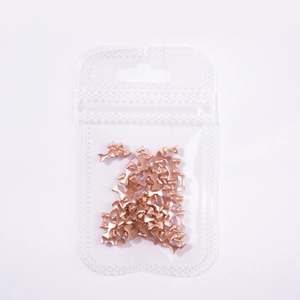 Mini rose gold 3D metal bow nail art charms in a clear pack for manicures
