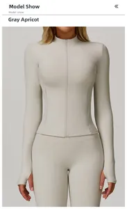 Detail of gray apricot yoga jacket with stand collar, zip pockets and thumb holes