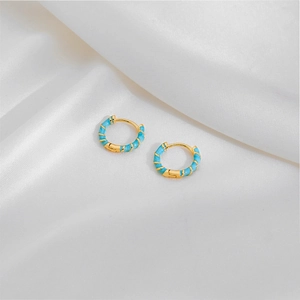 Minimalist geometric gold hoop earrings with sky blue enamel spiral texture