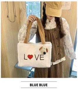 Close-up of white plush tote bag featuring red heart LOVE embroidery and puppy charm