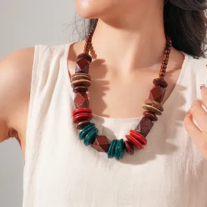 Bohemian retro necklace with brown wood beads and red green disc accents on a model