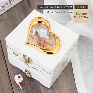 Detailed white heart-window music box featuring a violin model and ballet dancer figurine