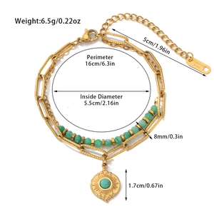 Detail of stainless steel bracelet with green natural stones and golden sun pendant