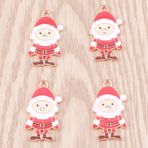Detail of 4 Santa Claus alloy charms with rose gold edges and small rhinestones