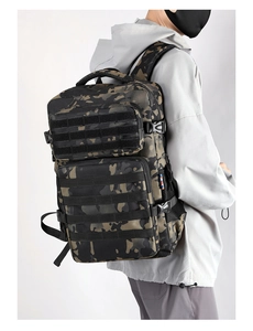 Side view of large tactical camo backpack worn by model showing MOLLE webbing and buckles