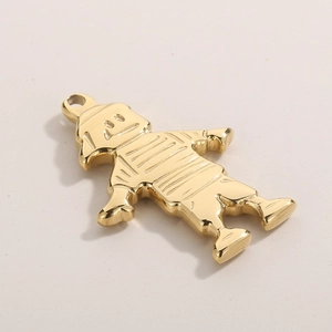 Macro detail of a stylized hip-hop boy pendant in polished gold metal with glossy finish